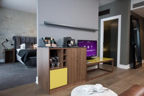 a living room with a tv and a couch at Malmaison Birmingham in Birmingham