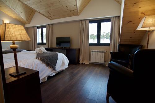 une chambre d'hôtel avec un lit et une chaise dans l'établissement Grand Hotel Caviahue, à Caviahue