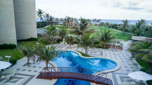 an aerial view of a swimming pool at a resort at Scopa Beach Resort Cavalcanti in Aquiraz