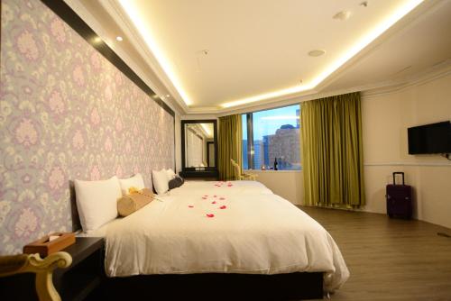 a bedroom with a large bed with flowers on it at 友愛金色商旅Golden Age Hotel in Taipei