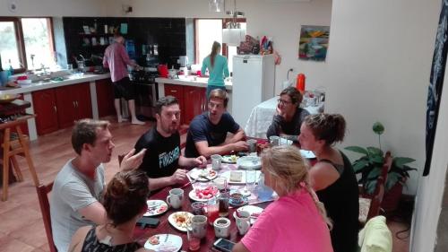a group of people sitting around a table eating at Hostel Serena in Samaipata