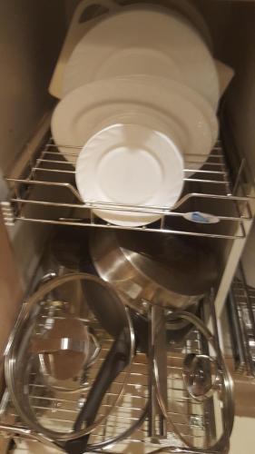 a stack of plates and utensils in a dishwasher at Relaxing Wind in Tagaytay