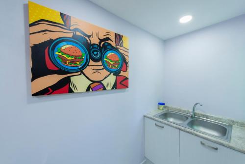 a painting of a man with a hamburger at Once21 Apartment in Guadalajara