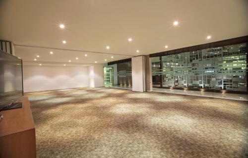 a large room with a television and a building at Oakwood Residence Whitefield Bangalore in Bengaluru