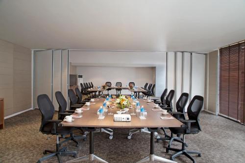 a large conference room with a long table and chairs at Oakwood Residence Whitefield Bangalore in Bengaluru