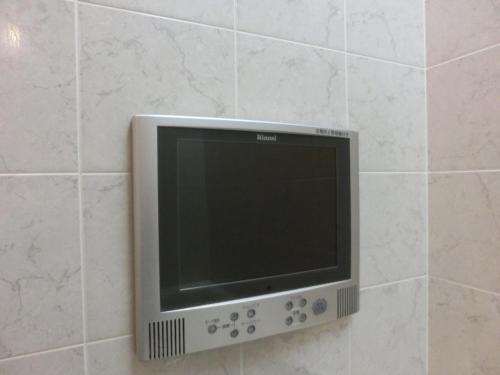 a flat screen tv on a tiled wall at Hotel Hyper Noah (Adult Only) in Sakai