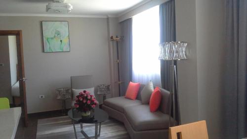 a living room with a couch and a window at Ambassador Hotel in Addis Ababa