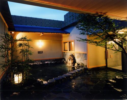 a koi pond in the middle of a house at Yuno Yado Shoei in Kyoto