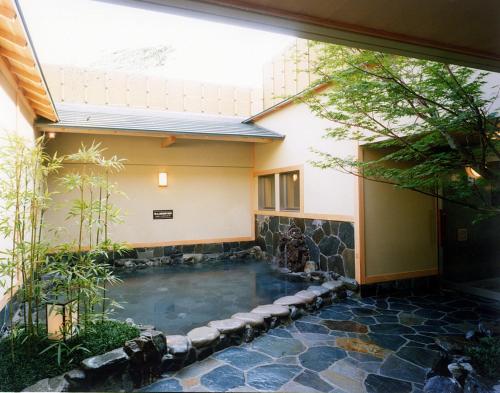 a swimming pool in the courtyard of a house at Yuno Yado Shoei in Kyoto