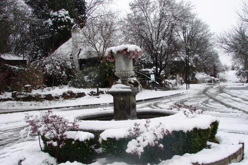 a fountain in a yard covered in snow at Rawdons Hotel & Brewery in Nottingham Road