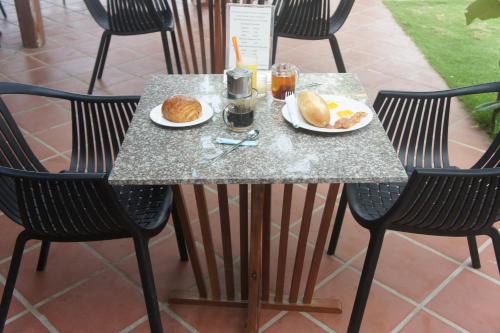 a table with two plates of food and drinks on it at Phu Quoc Kim - Bungalow On The Beach in Phu Quoc