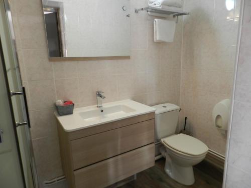 a bathroom with a sink and a toilet at Hôtel et Appart 'hôtel Chez Gino ETAPLES-Le Touquet in Étaples