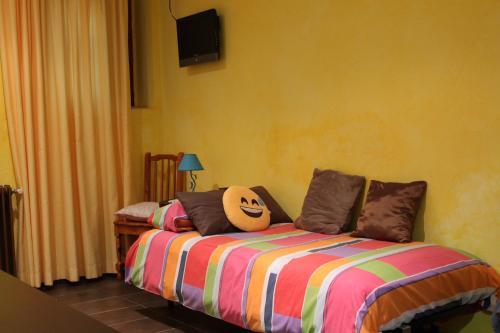 a bedroom with a bed with pillows on it at Hotel Restaurante Sonsoles in Avila