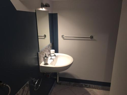 a bathroom with a white sink and a mirror at Cialoma B&B in Palermo