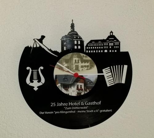 a clock with some buildings and buildings at Gasthof zum Döhlerwald in Klingenthal
