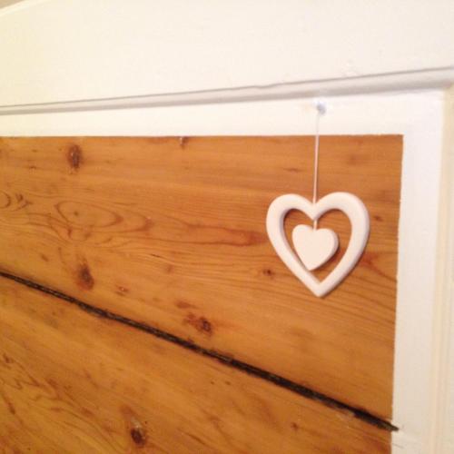 a heart hanging on a wall at Palazzo Kapece in Monopoli