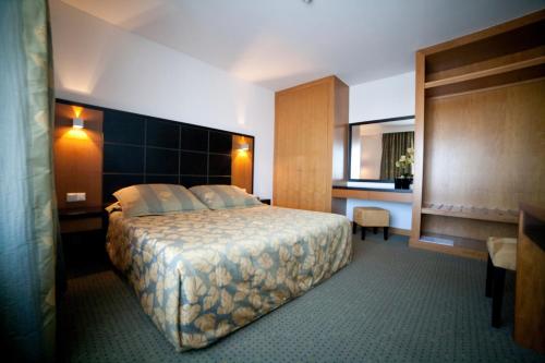 מיטה או מיטות בחדר ב-Hotel Bagoeira