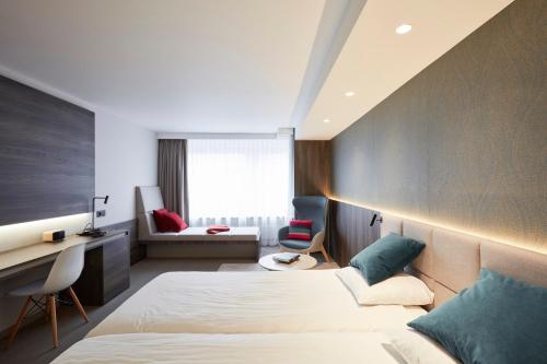 a hotel room with a bed and a desk at Hotel Nelson in Knokke-Heist