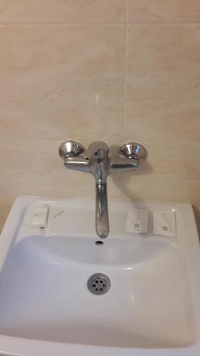 a bathroom sink with a silver faucet at Magnolia Guest house in Haskovo