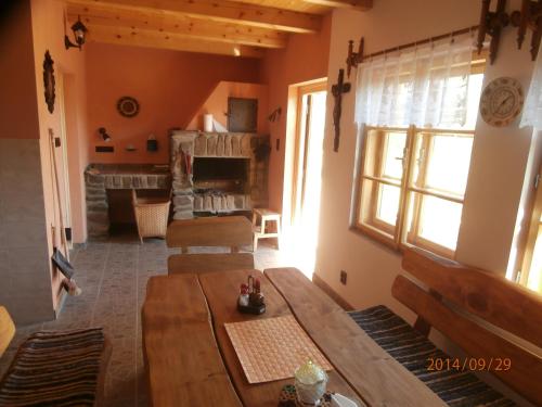 a living room with a table and a fireplace at Penzion U Dvou slunci in Stachy