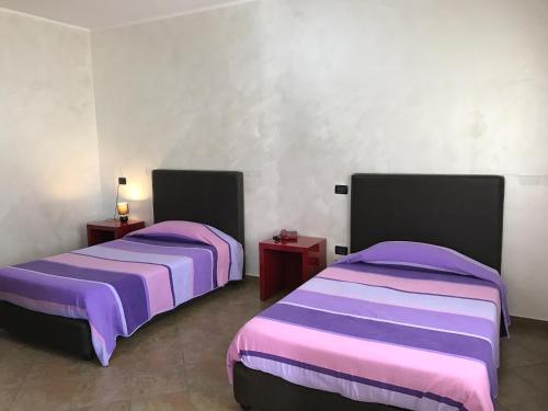 Säng eller sängar i ett rum på Hotel Toscano