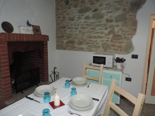 a dining room with a table and a fireplace at La Casa Dei Nonni in Cortona