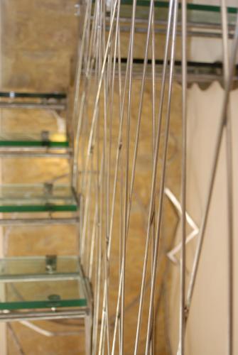 a close up of a wooden staircase with metal poles at Morelliana4Rooms in Scansano