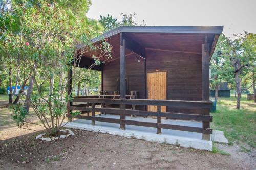 a small cabin with a wooden door in a park at Villaggio Camping Uria in Foce Varano