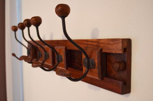 a wooden towel rack hanging on a wall at B&B L'Alberone in Budrio