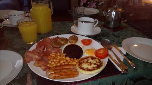 a plate of breakfast food on a table at Crawfords Guest house in Peterhead
