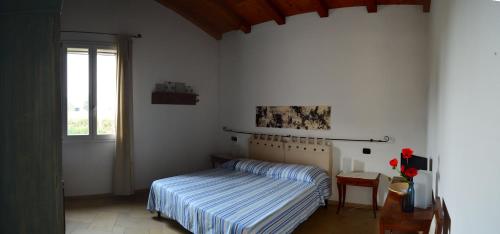 a bedroom with a bed and a window at B&B L'Alberone in Budrio