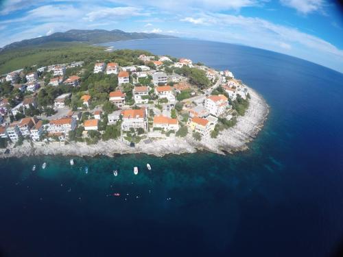 an island with houses and boats in the water at Apartments Ranko in Zavalatica