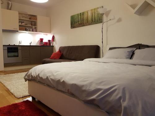 a bedroom with a bed and a couch at Rotermanni Guest Apartments in Tallinn