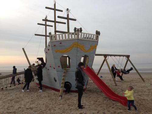 a group of people playing on a playground on the beach at Studio Zeezicht in Ostend