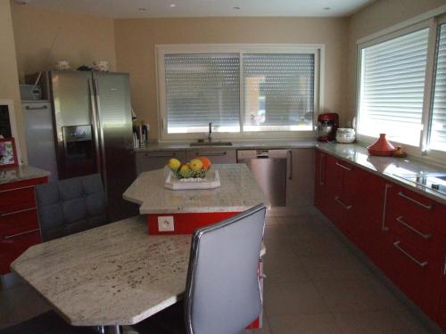 a kitchen with a counter with a bowl of fruit on it at Chez Christiane Et Gerard in Orthez