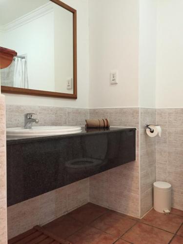 een badkamer met een wastafel en een spiegel bij Keurbooms River Lodge 1014 in Plettenbergbaai
