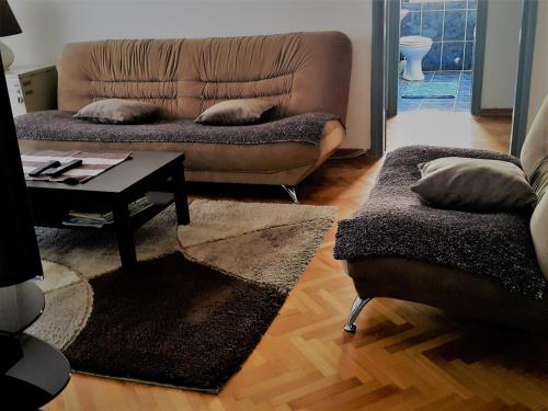 a living room with a couch and a coffee table at Centre Point Apartment in Podgorica