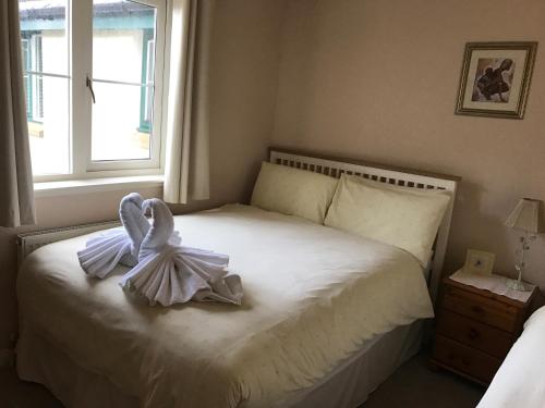a bedroom with a bed with two swans on it at Wellingtonia Apartment in Inverness