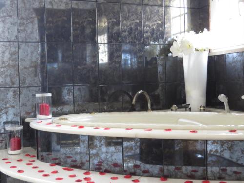 a bathroom with a bath tub with red polka dots at Villa Moments - Guest House in Portimão