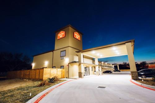 a building with a clock tower in a parking lot at Palace Inn-529 in Hot Wells