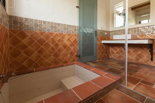 a bathroom with a shower with a tub at Charmole in Wujie