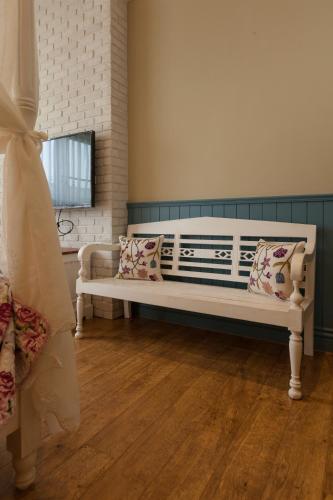 a white bench with pillows in a room at Charmole in Wujie