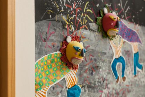 two clown ornaments hanging on a wall at Charmole in Wujie