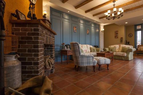 a living room with chairs and a brick fireplace at Charmole in Wujie
