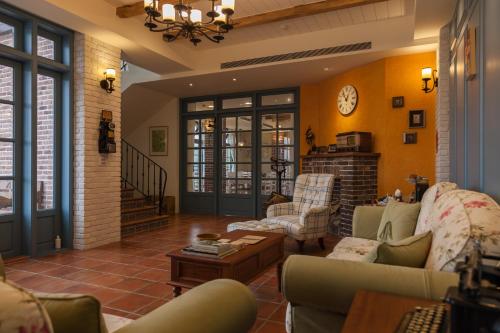 a living room with couches and a clock on the wall at Charmole in Wujie