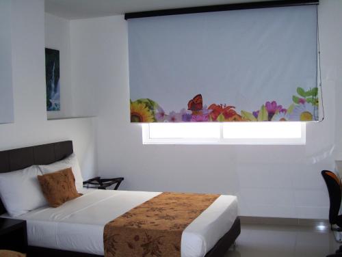 Cama ou camas em um quarto em hgo hotel