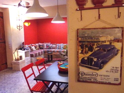 a living room with a table and a car on the wall at Alegria Villas Complex in Vasilikos
