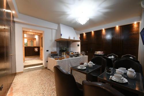 a dining room with a table and chairs and a room with a table at Locanda Leon Bianco on the Grand Canal in Venice