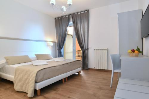 a bedroom with a large bed and a window at La Casa in Piazza in Massa Lubrense