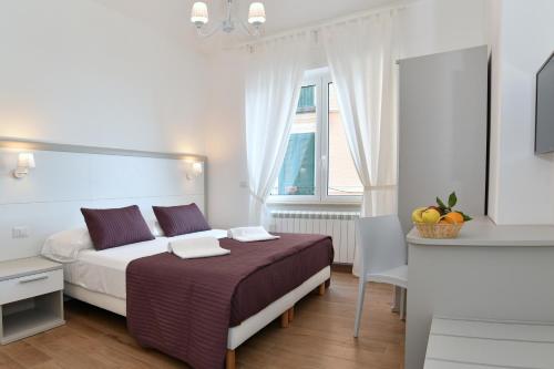 a hotel room with a bed and a window at La Casa in Piazza in Massa Lubrense